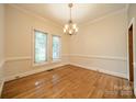 Bright dining room features hardwood floors, crown molding, and a chandelier fixture at 4509 Rosecliff Dr, Charlotte, NC 28277