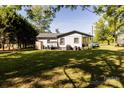 Expansive backyard featuring a well-maintained lawn and mature trees, offering ample outdoor space at 5014 Oxford School Rd, Claremont, NC 28610