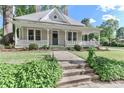 Charming home featuring a welcoming front porch and a well-maintained landscaped yard at 531 Walnut St, Statesville, NC 28677