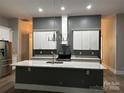 Contemporary kitchen featuring a large island, sleek countertops, and modern appliances at 531 Walnut St, Statesville, NC 28677