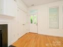 Bright entryway with hardwood floors, white trim, and a door leading to the outdoors at 541 Jetton St, Davidson, NC 28036