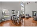 Bright living space featuring tall ceilings, many windows, hardwood floors, and modern furnishings at 5621 Tipperlinn Way, Charlotte, NC 28278