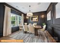 Elegant dining room featuring dark accent wall and modern chandelier at 6308 Honor Ave, Midland, NC 28107