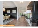 Inviting entryway with hardwood floors, a dark accent wall, and stylish decor at 6308 Honor Ave, Midland, NC 28107