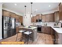 Stylish kitchen with stainless steel appliances, island with seating, and modern lighting at 6308 Honor Ave, Midland, NC 28107