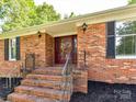 Close-up of the front entrance with brick steps and a decorative front door at 70 Cumberland Sw Ct, Concord, NC 28025