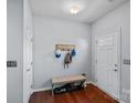 Bright foyer with hardwood floors, coat rack, and bench for added convenience and organization at 7332 Newsome Sw Ct, Concord, NC 28025