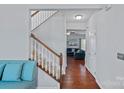 Hallway with staircase leads to a comfortable living area at 7332 Newsome Sw Ct, Concord, NC 28025