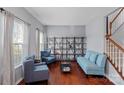 Inviting living room with hardwood floors, ample shelving, and comfortable seating for relaxation at 7332 Newsome Sw Ct, Concord, NC 28025