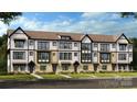 New construction townhome featuring a sophisticated mix of white and brick facade at 739 Hoke Ln, Davidson, NC 28036