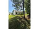 The property features a spacious green backyard, offering plenty of room for outdoor activities and relaxation at 8708 Goldfields Dr, Charlotte, NC 28227