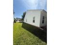 Lush green side yard with well-maintained lawn, providing a serene and inviting outdoor space at 8708 Goldfields Dr, Charlotte, NC 28227