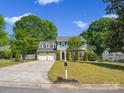 Beautiful two-story home with a well-kept lawn, mature trees, and a convenient two-car garage at 9430 Peckham Rye Rd, Mint Hill, NC 28227