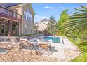 Backyard pool with lounge seating and stone accents provides a relaxing outdoor living space at 9433 Stonebridge Way, Mint Hill, NC 28227