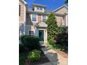 Charming townhome featuring a well-manicured front yard and a welcoming dark green front door at 10649 Trolley Run Dr, Cornelius, NC 28031