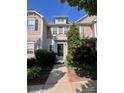 Charming townhome featuring a well-manicured front yard and a welcoming dark green front door at 10649 Trolley Run Dr, Cornelius, NC 28031