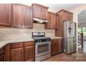 Kitchen featuring stainless steel appliances and granite countertops with wooden cabinets at 1071 Bassett Way, Fort Mill, SC 29707