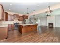 Spacious open-concept kitchen, island and living room with modern stainless appliances at 1071 Bassett Way, Fort Mill, SC 29707