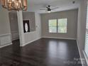 Bright living room with hardwood floors, ceiling fan, and large windows providing plenty of natural light at 1071 Bassett Way, Fort Mill, SC 29707