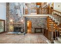 Spacious living room with brick flooring, fireplace, grand staircase, and an open, airy feel at 1160 Walton Pl, Salisbury, NC 28146