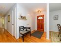 Inviting entryway with hardwood floors and a stained wood door and traditional decor at 13030 Mayes Rd, Huntersville, NC 28078