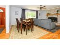 Open concept living room with hardwood floors, fireplace, and a large window at 13030 Mayes Rd, Huntersville, NC 28078