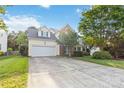 Charming two-story home with a well-manicured front yard and attached two-car garage at 1308 Pennington Nw Pl, Concord, NC 28027