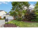 Charming two-story home with a well-manicured front yard, green grass and two-car garage at 1308 Pennington Nw Pl, Concord, NC 28027