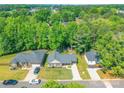 Aerial view of a well-maintained residential neighborhood with lush greenery and spacious lots at 137 Ole Eastpointe Dr, York, SC 29745