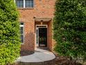 Inviting front entrance features a classic black door framed by lush greenery, enhancing curb appeal at 140 Villa Lake Dr, Fort Mill, SC 29708
