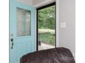 View from inside showing the bright blue front door with decorative glass and view to a grassy front yard at 192 Bailey Ave, Rock Hill, SC 29732