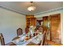 Charming dining room with a round table, decorative wallpaper, and wood accents at 211 Amos Homesley Rd, Cherryville, NC 28021