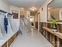 Inviting entryway with rustic wood paneling, hooks for storage, and a staircase leading upstairs at 2125 Belle Vernon Ave, Charlotte, NC 28210