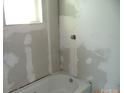 Bathroom with a new tub and window at 216 N Rowan Ave, Spencer, NC 28159