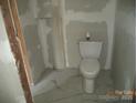 Bathroom with a new toilet and tile floor at 216 N Rowan Ave, Spencer, NC 28159