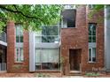 Close-up view of modern brick townhouse with a unique architectural style and multiple large windows at 226 Magnolia Ave, Charlotte, NC 28203