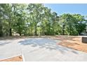 Expansive backyard offering a blank canvas with newly seeded grass and mature trees at 2506 Glendale Ave, Kannapolis, NC 28081