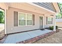 Close-up of the front porch featuring gray siding, and a brick-lined concrete patio at 2506 Glendale Ave, Kannapolis, NC 28081
