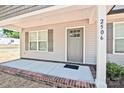 Front porch view highlighting house number, gray siding, and a multi-paneled front door at 2506 Glendale Ave, Kannapolis, NC 28081