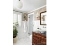Bright bathroom featuring a vessel sink, marble floors, and modern glass shower, enhancing its luxurious feel at 290 Union S St, Concord, NC 28025