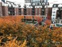 Autumnal trees surround a courtyard with pool, gazebo and manicured green in an urban setting at 300 W 5Th St # 404, Charlotte, NC 28202