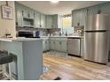 Modern kitchen with stylish blue cabinets, stainless steel appliances, and bar seating at 3154 Loomis St, Lincolnton, NC 28092