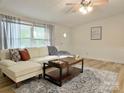 Cozy living room featuring a plush sofa, decorative rug, and ample natural light at 3154 Loomis St, Lincolnton, NC 28092