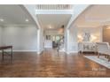 Spacious foyer featuring gleaming hardwood floors and abundant natural light from the large windows at 3304 Danhill Pl, Matthews, NC 28105