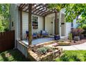 Inviting covered front porch with a pergola, stone accents, and comfortable seating at 3307 Draper Ave, Charlotte, NC 28205