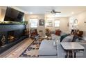 Comfortable living room featuring a brick fireplace, stylish furnishings, and ample natural light at 3307 Draper Ave, Charlotte, NC 28205