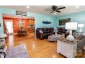 Inviting living room with warm hardwood floors, a plush brown leather sectional, and connecting dining area at 3310 46Th Ne Ave, Hickory, NC 28601