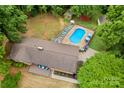 Expansive aerial view of the property, highlighting the in-ground pool, and wooded surroundings at 366 Faith Rd, Mooresville, NC 28115