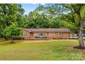 Inviting brick home with a spacious front yard and a welcoming porch, perfect for enjoying the outdoors at 366 Faith Rd, Mooresville, NC 28115