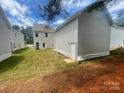 The backyard featuring a newly built home and a well-maintained lawn at 4017 Grommet Ct, Matthews, NC 28105